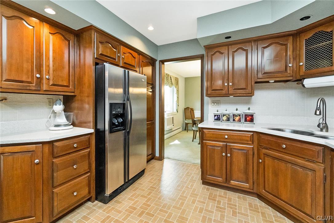 7116 Linden Road Lower Macungie Township, PA 18062 - Photo 9 of 41 a kitchen with stainless steel appliances granite countertop a refrigerator and cabinets