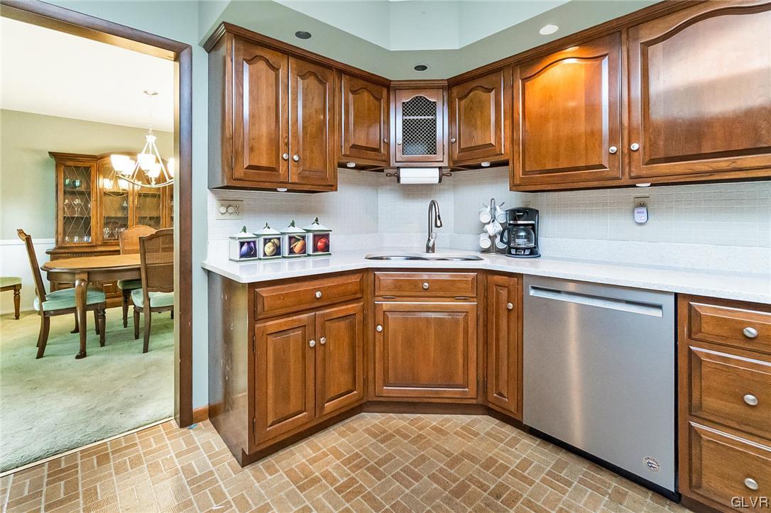 7116 Linden Road Lower Macungie Township, PA 18062 - Photo 10 of 41 a kitchen with stainless steel appliances granite countertop wooden cabinets a sink and dishwasher