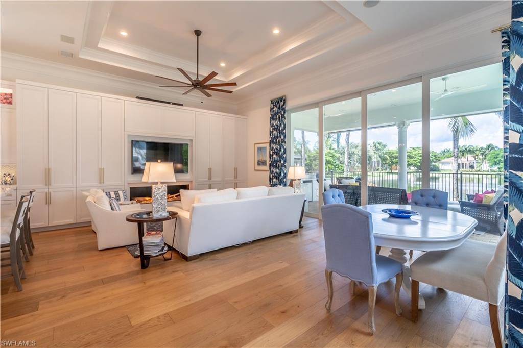 2125 Modena Court Naples, FL 34105 - Photo 12 of 50 a view of a dining room with furniture window and wooden floor