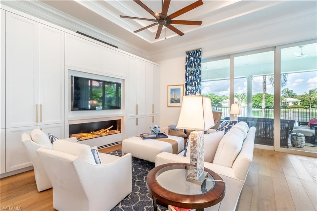 2125 Modena Court Naples, FL 34105 - Photo 13 of 50 a living room with furniture a large window and a flat screen tv