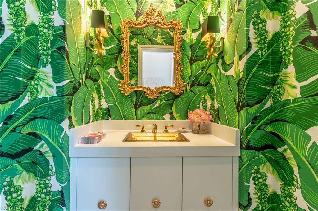 2125 Modena Court Naples, FL 34105 - Photo 22 of 50 a bathroom with a sink and mirror