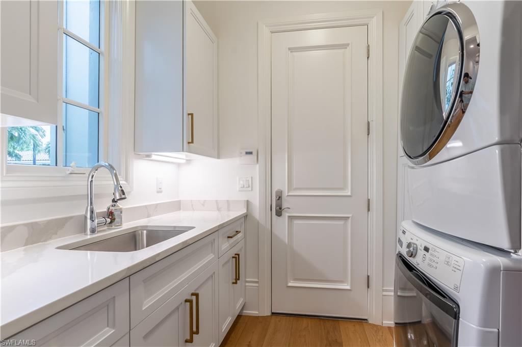 2125 Modena Court Naples, FL 34105 - Photo 29 of 50 a kitchen with a sink and a washer dryer