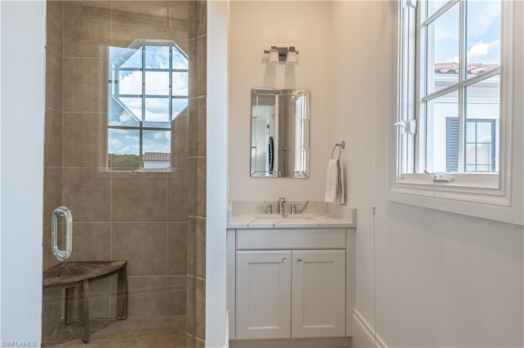 2125 Modena Court Naples, FL 34105 - Photo 33 of 50 a bathroom with a sink a toilet and a window