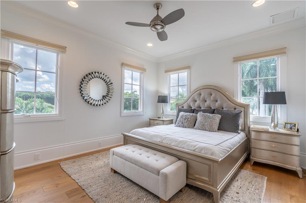 2125 Modena Court Naples, FL 34105 - Photo 34 of 50 a bedroom with a large bed and a window