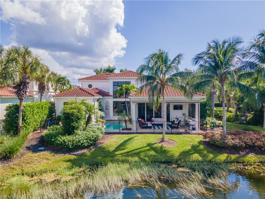 2125 Modena Court Naples, FL 34105 - Photo 36 of 50 a house with palm tree in front of it