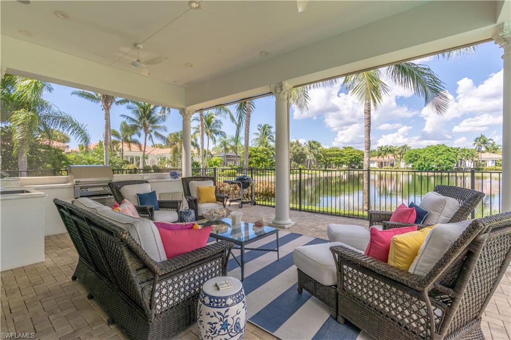 2125 Modena Court Naples, FL 34105 - Photo 38 of 50 a living room with furniture and a floor to ceiling window