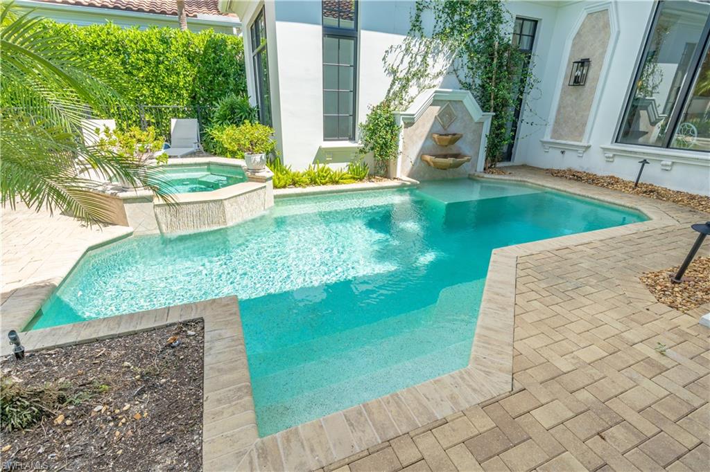 2125 Modena Court Naples, FL 34105 - Photo 43 of 50 swimming pool view with a garden space