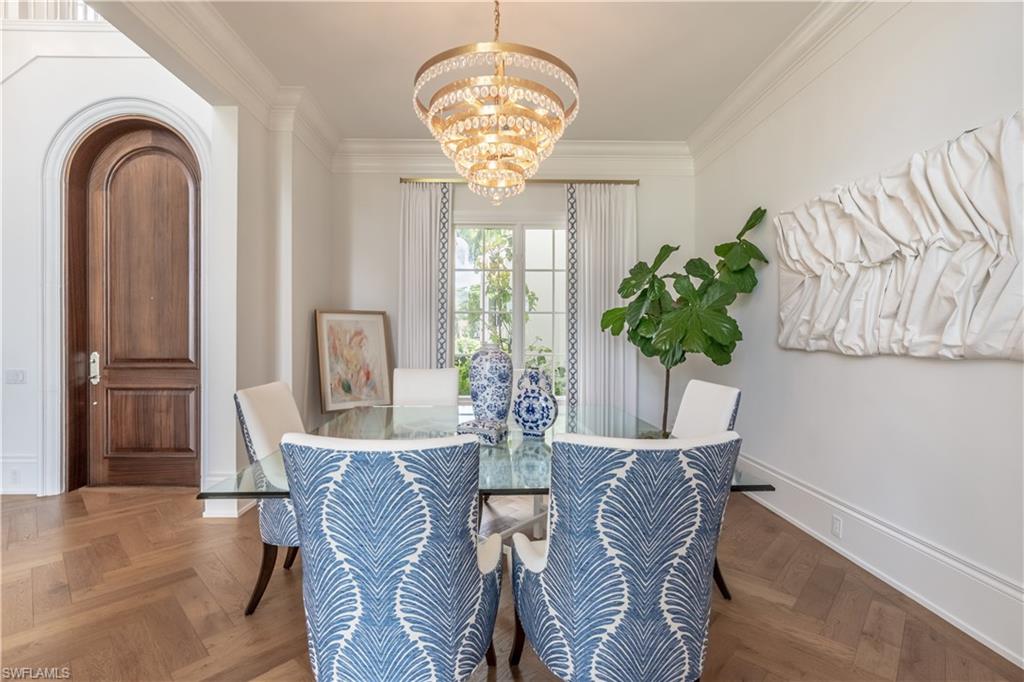 2125 Modena Court Naples, FL 34105 - Photo 10 of 50 a view of a dining room with furniture and a chandelier