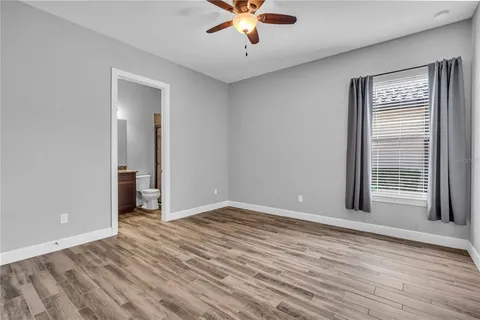 a view of an empty room with a ceiling fan
