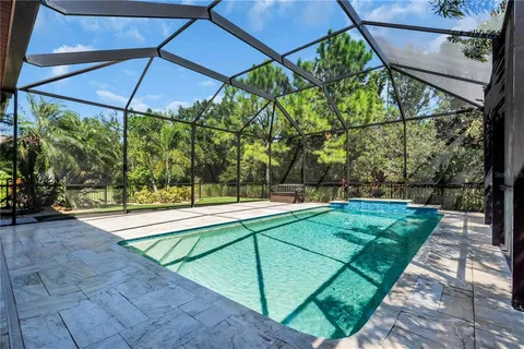 an aerial view of residential houses with outdoor space and swimming pool