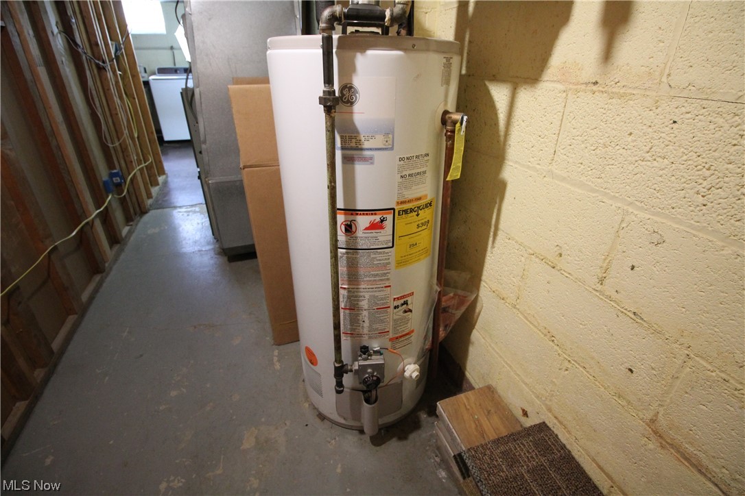 8025 Ackley Road Parma, OH 44129 - Photo 26 of 31 Unfinished half of basement. Hot water tank