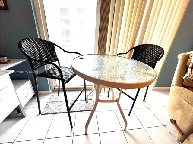a balcony view with a table and chairs