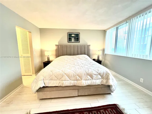 a large white bed in a white room