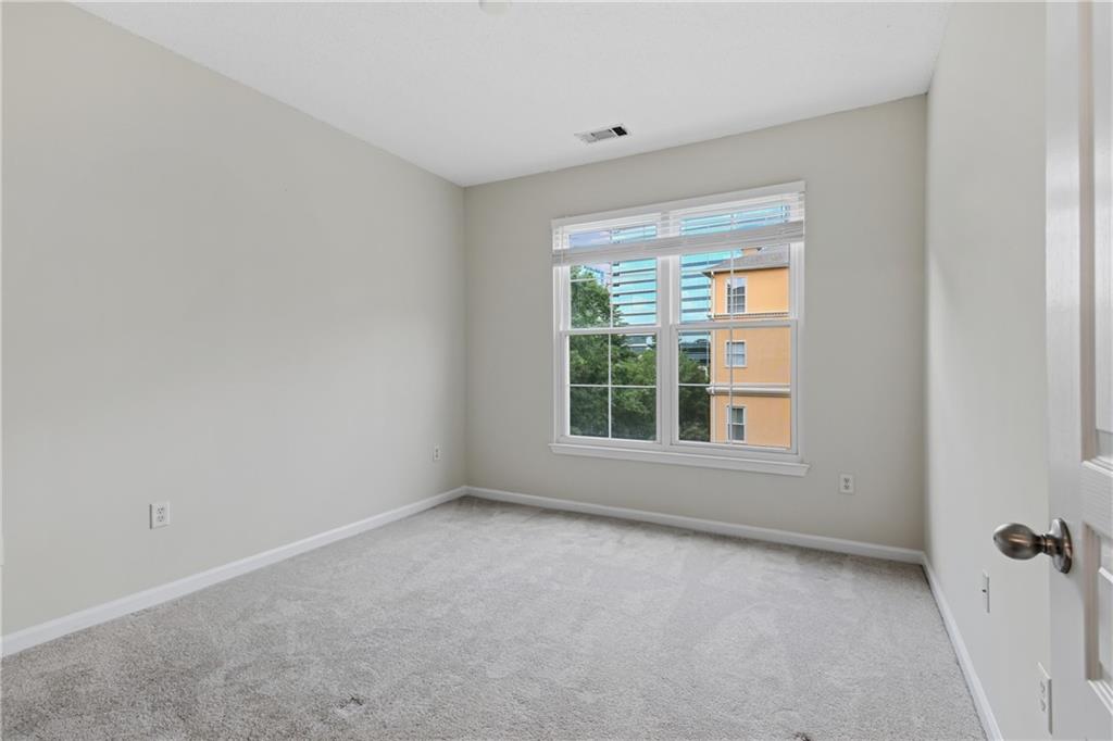 10 Perimeter Summit Boulevard, Unit 3311 Atlanta, GA 30319 - Photo 65 of 68 an empty room with a window