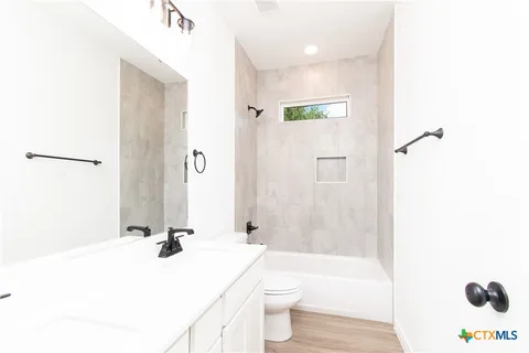 a bathroom with a sink a toilet and a bathtub