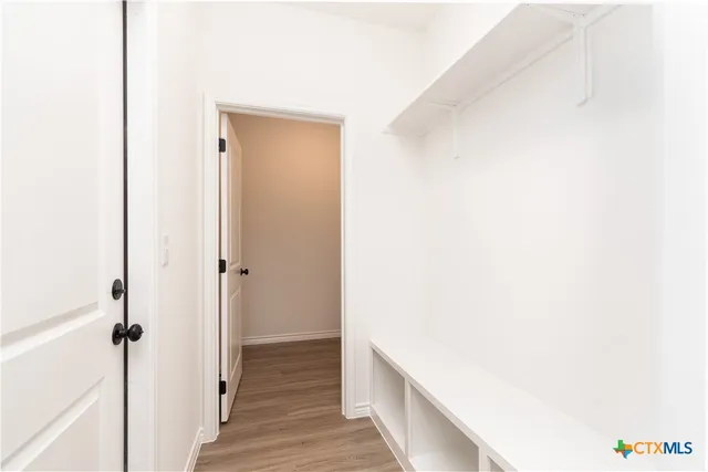 a view of hallway with wooden floor