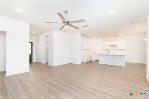 a view of a kitchen with a sink and wooden floor