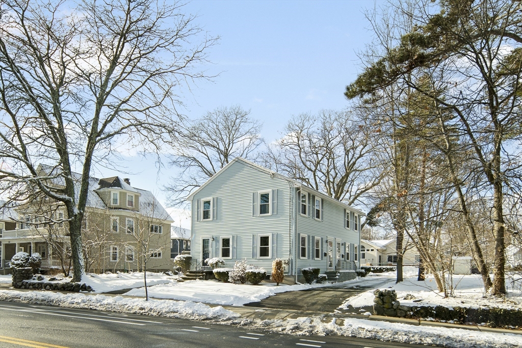 a front view of a building with trees