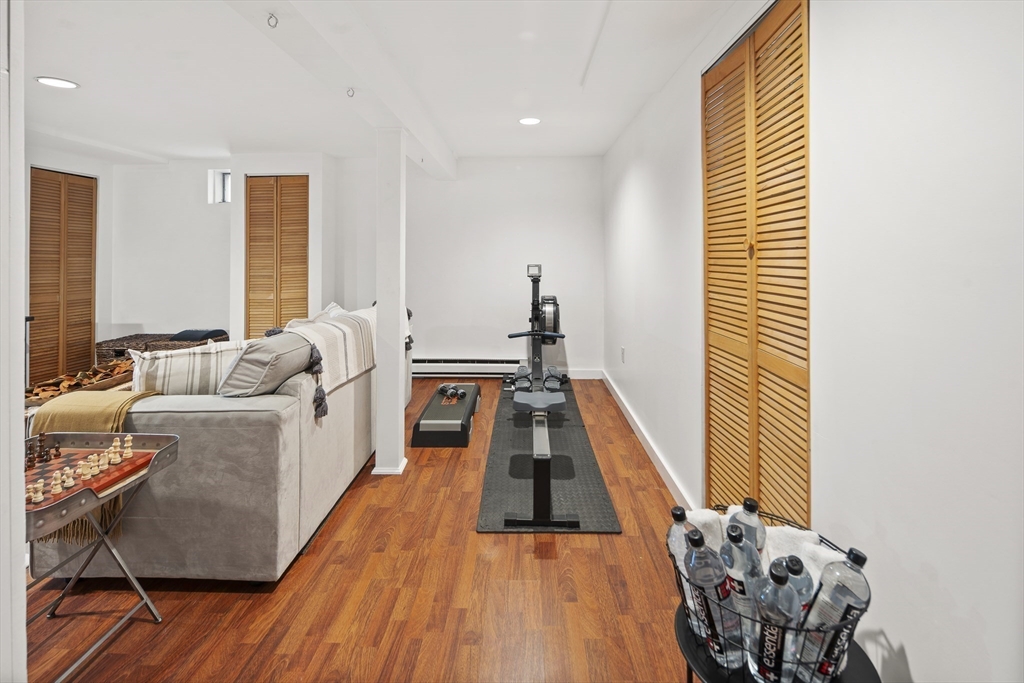 120 Medford Street, Unit 120 Arlington, MA 02474 - Photo 17 of 25 a living room with furniture and a wooden floor