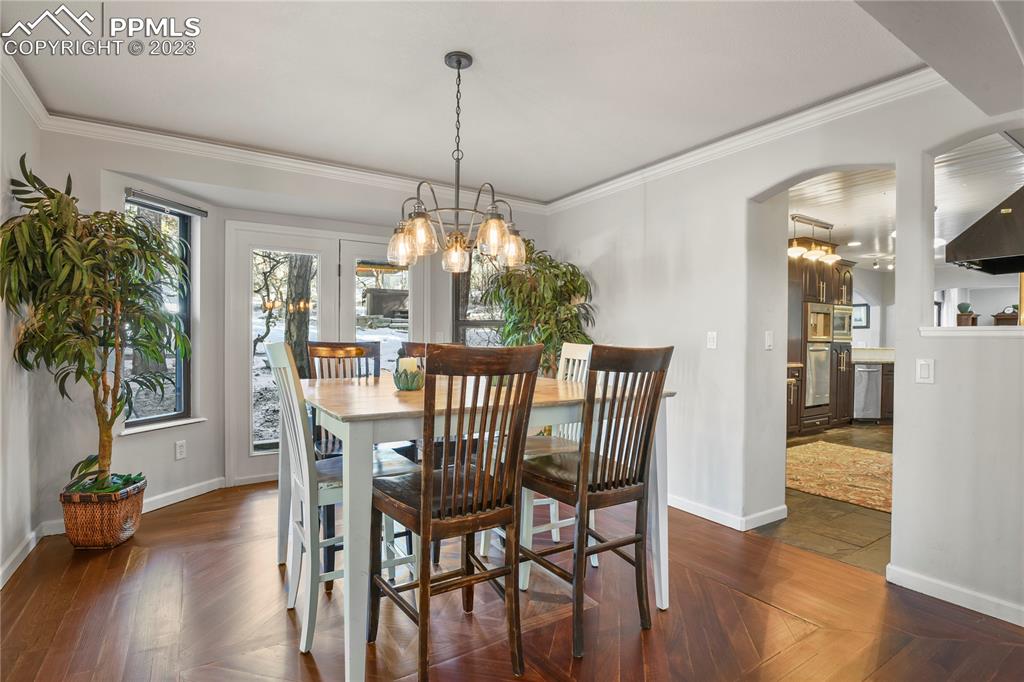 450 Jack Boot Road Monument, CO 80132 - Photo 11 of 45 a view of a dining room with furniture window and wooden floor