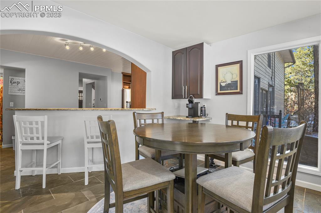 450 Jack Boot Road Monument, CO 80132 - Photo 15 of 45 a view of a dining room with furniture and wooden floor
