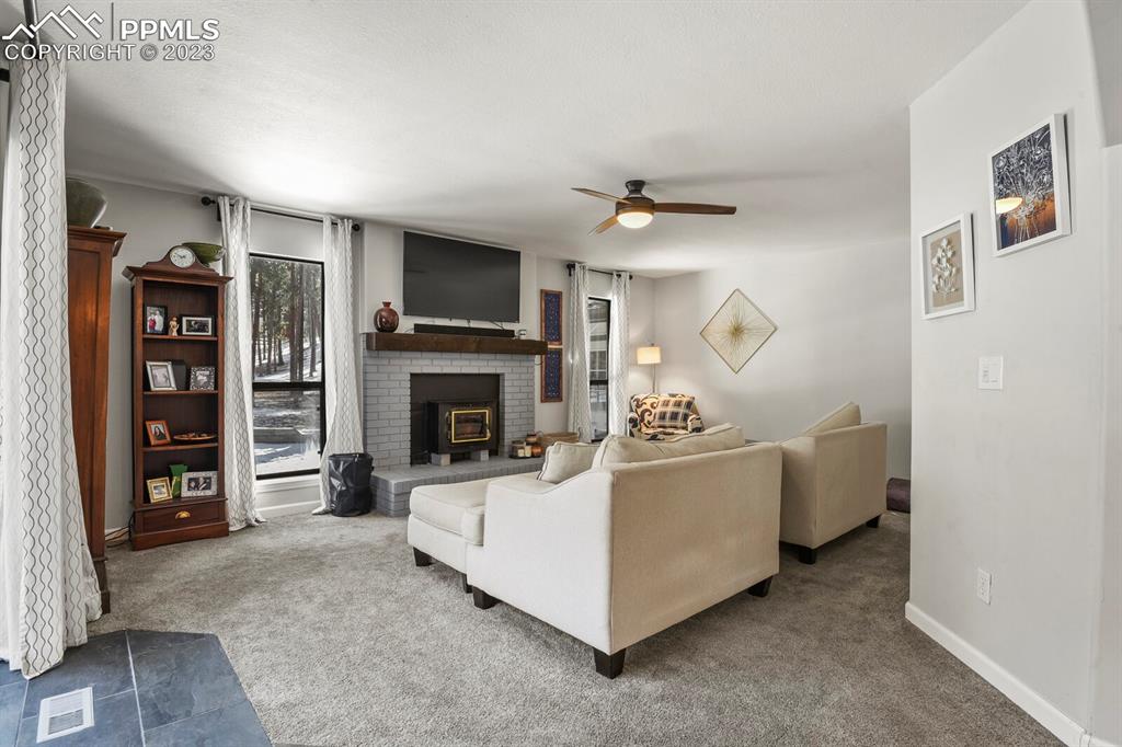 450 Jack Boot Road Monument, CO 80132 - Photo 17 of 45 a living room with furniture and a fireplace