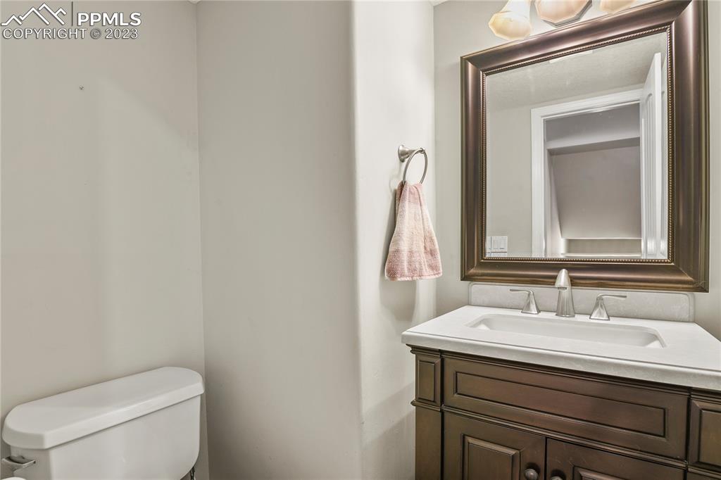 450 Jack Boot Road Monument, CO 80132 - Photo 18 of 45 a bathroom with a toilet sink and mirror