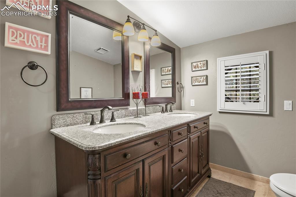 450 Jack Boot Road Monument, CO 80132 - Photo 25 of 45 a view of bathroom with a sink and a mirror