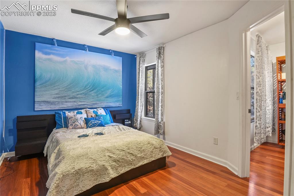 450 Jack Boot Road Monument, CO 80132 - Photo 27 of 45 a bedroom with a bed and a painting on the wall