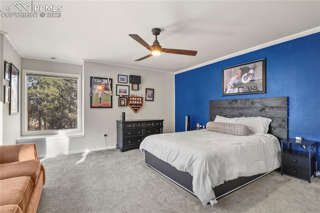 450 Jack Boot Road Monument, CO 80132 - Photo 29 of 45 a bedroom with a large bed and a couch