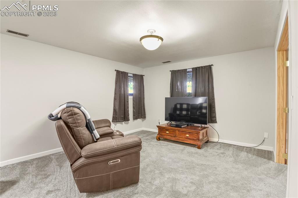 450 Jack Boot Road Monument, CO 80132 - Photo 33 of 45 a living room with furniture and a flat screen tv