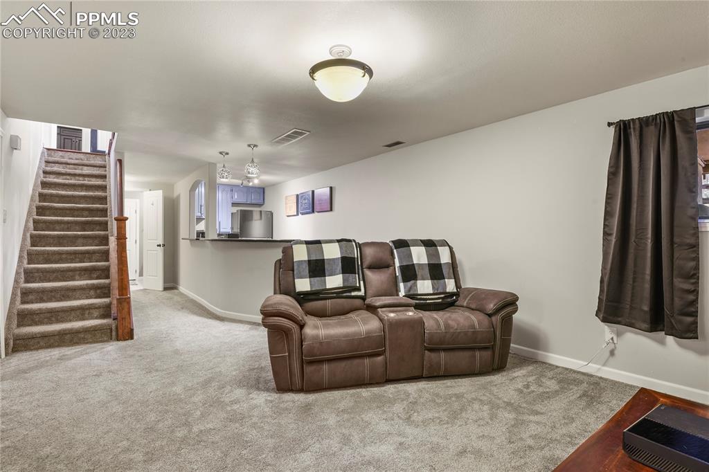 450 Jack Boot Road Monument, CO 80132 - Photo 34 of 45 a living room with furniture and a flat screen tv