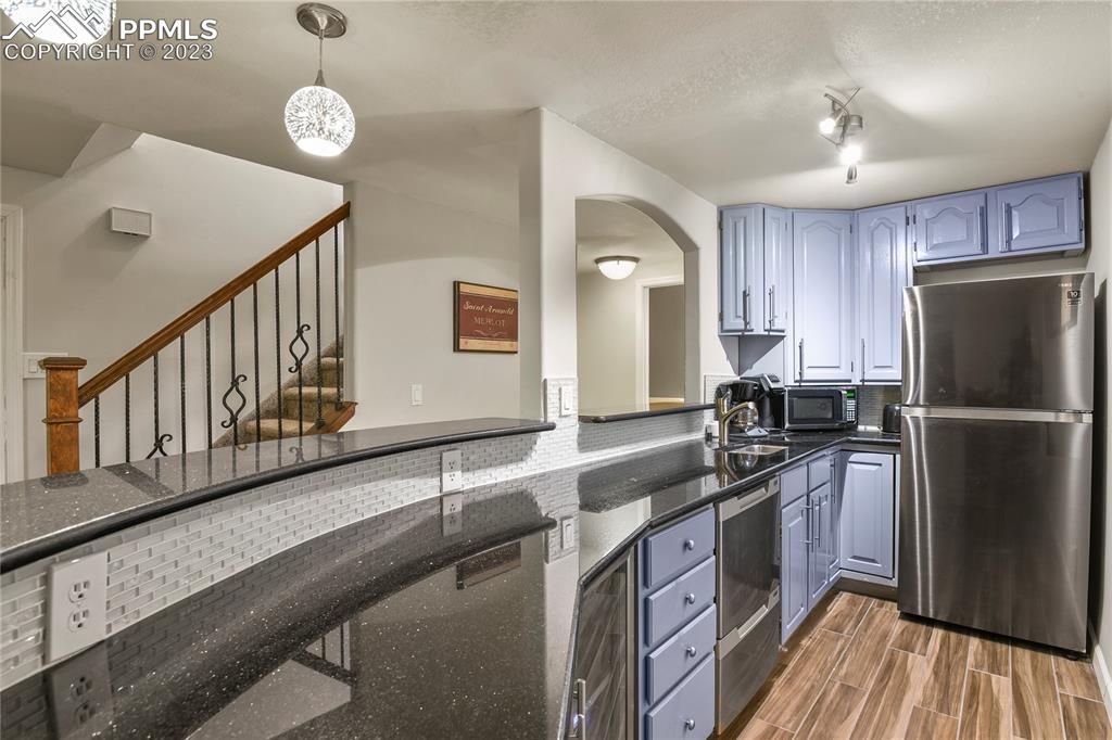 450 Jack Boot Road Monument, CO 80132 - Photo 36 of 45 a kitchen with stainless steel appliances granite countertop a sink stove and refrigerator