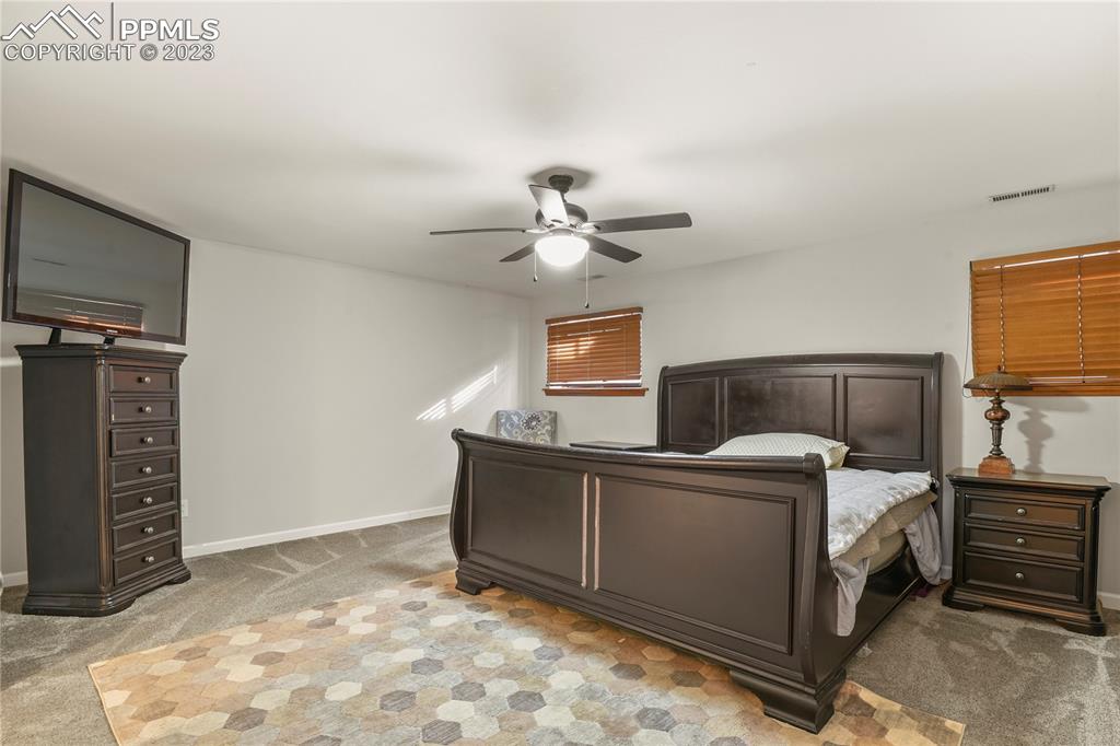 450 Jack Boot Road Monument, CO 80132 - Photo 38 of 45 a bed room with a bed and a television