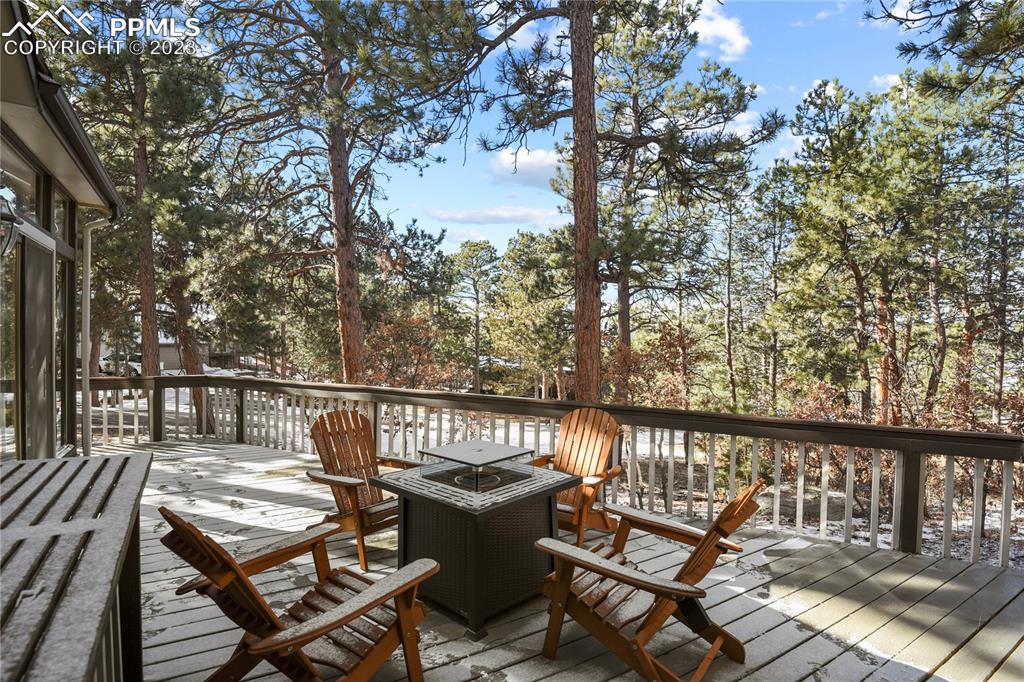 450 Jack Boot Road Monument, CO 80132 - Photo 41 of 45 a view of a balcony with wooden floor and outdoor seating