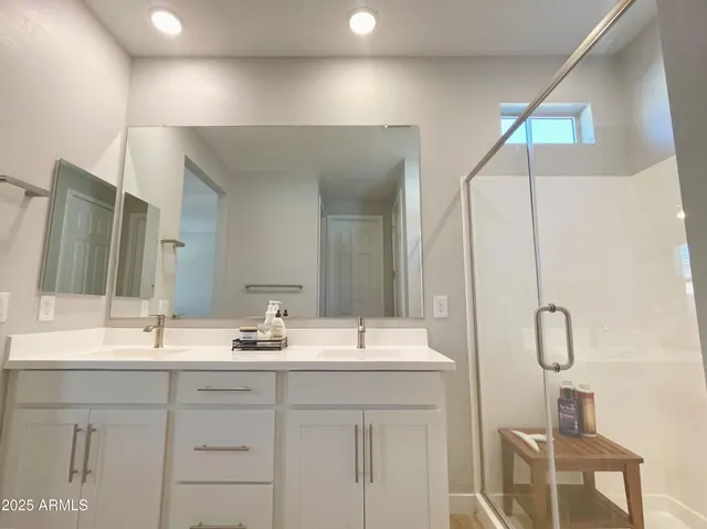 a bathroom with a double vanity sink and a mirror