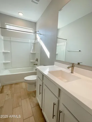 a bathroom with a sink a toilet and a shower