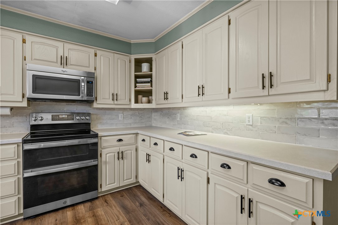 2601 Linwood Road Temple, TX 76502 - Photo 16 of 41 a kitchen with granite countertop white cabinets and appliances
