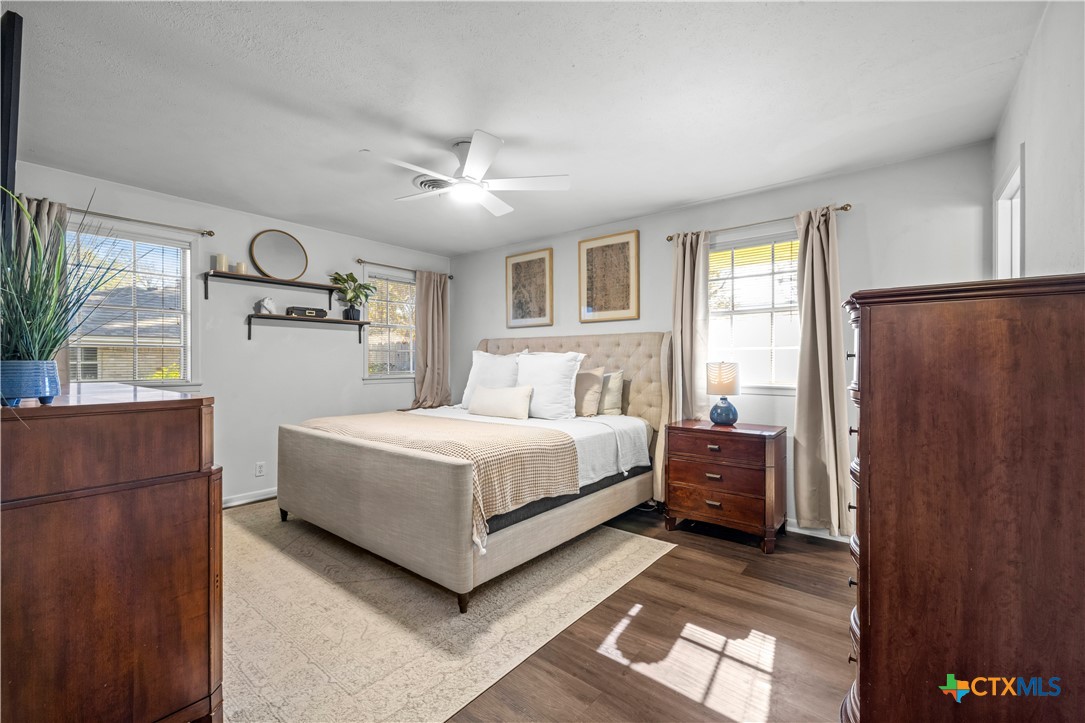 2601 Linwood Road Temple, TX 76502 - Photo 23 of 41 a bedroom with a large bed and a chandelier