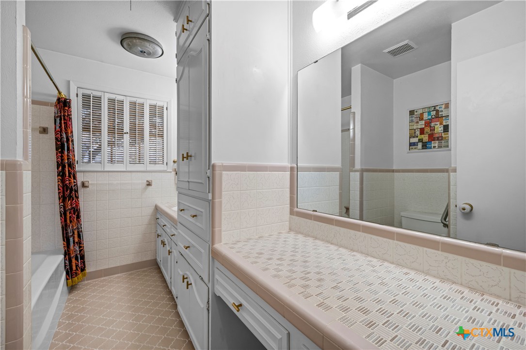 2601 Linwood Road Temple, TX 76502 - Photo 28 of 41 a bathroom with a granite countertop double vanity sink and a window