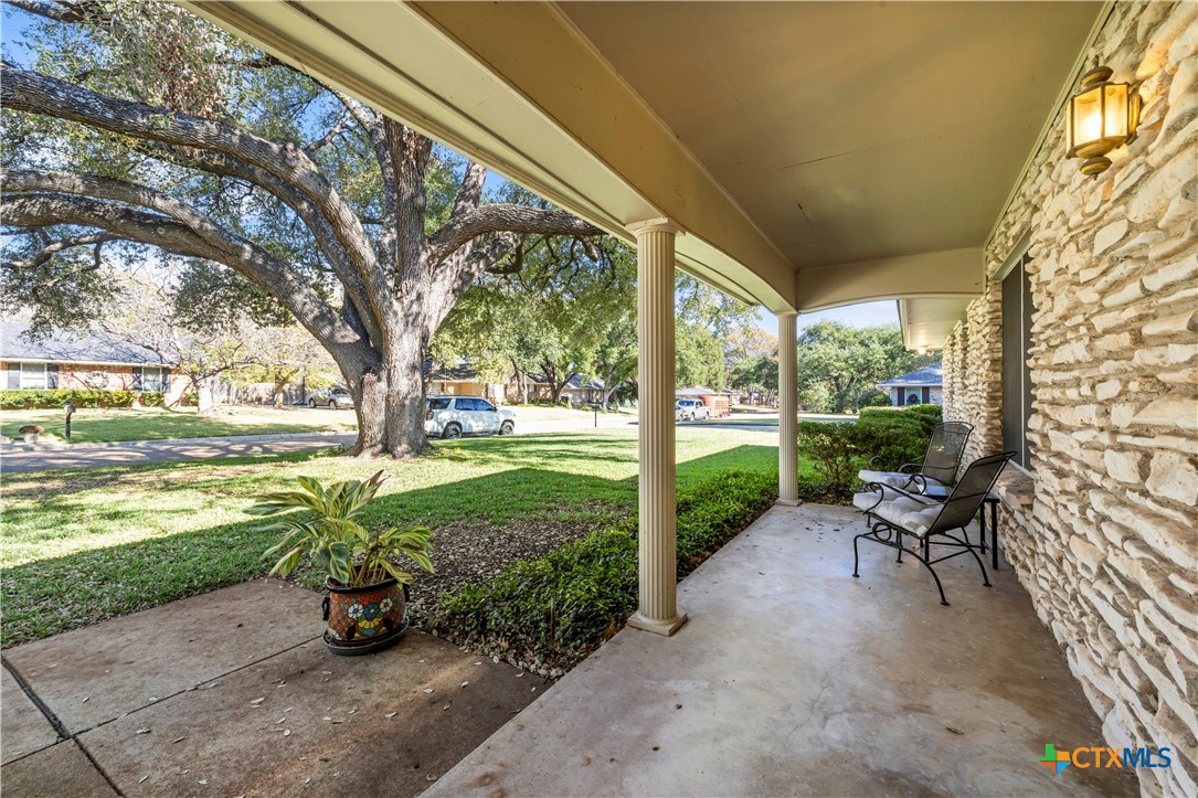2601 Linwood Road Temple, TX 76502 - Photo 4 of 41 a view of a patio with chairs and table with wooden fence next to a yard