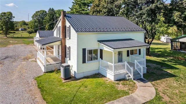 a view of a house with a yard patio and fire pit