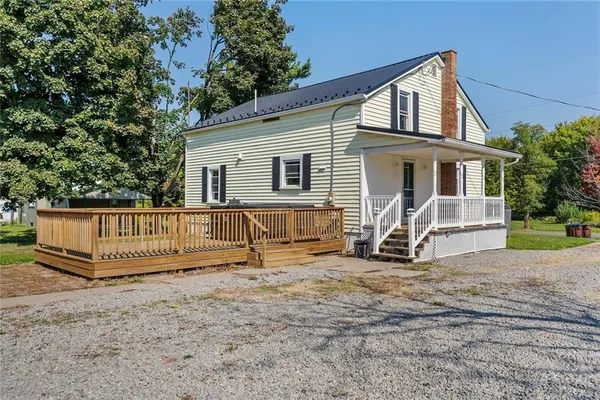 a backyard of a house with table and chairs