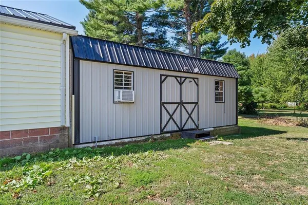 a view of a house with a wooden fence