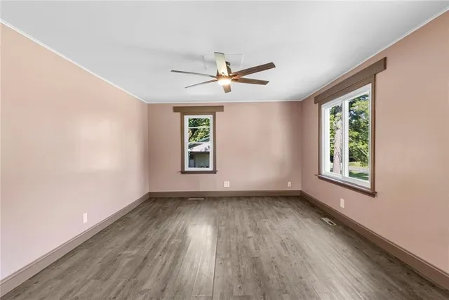 wooden floor in an empty room with a window