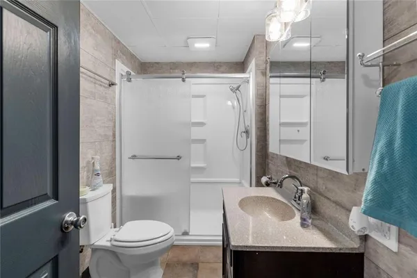 a bathroom with a sink toilet and shower