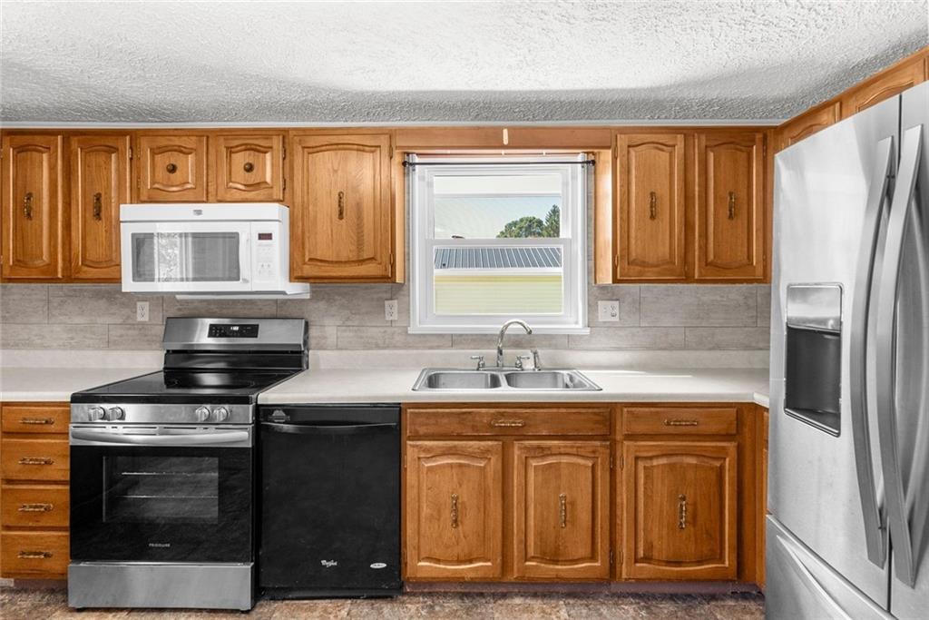 48 Kinsman Road Greenville, PA 16125 - Photo 22 of 42 a kitchen with stainless steel appliances granite countertop a stove a sink and a microwave