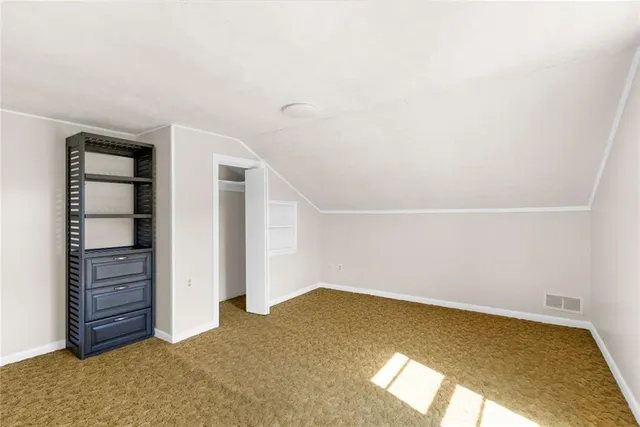 a view of empty room with closet