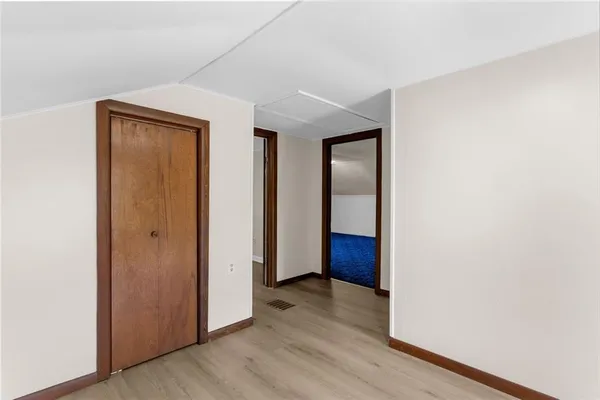 a view of hallway with wooden floor