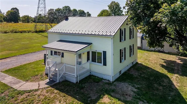a view of a house with pool and yard